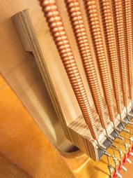 Laminated bridge construction on the Ritmuller piano